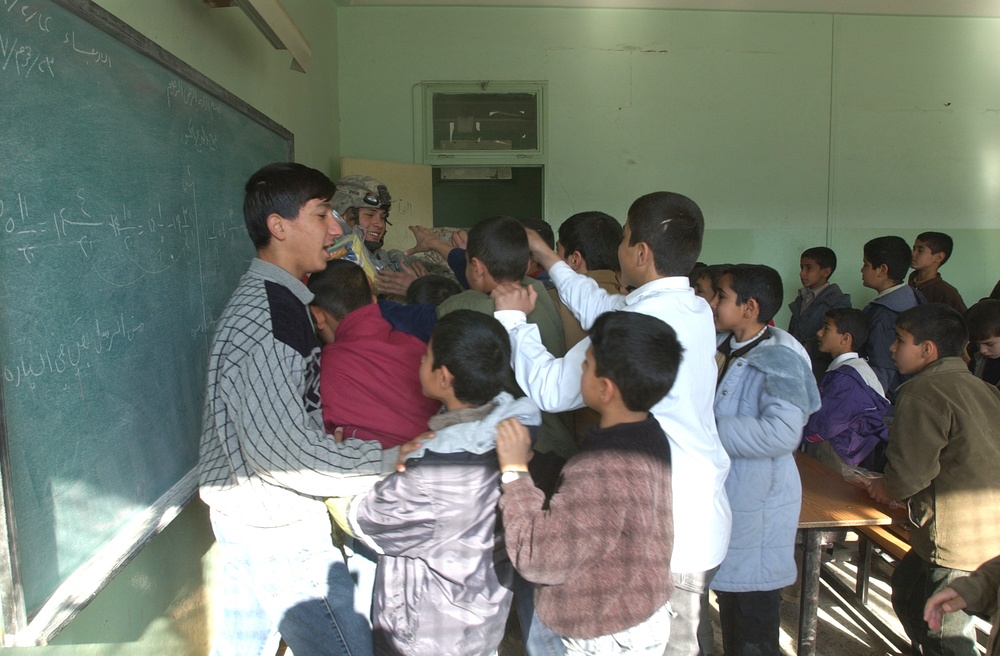 Soldiers Hand Out Supplies at Al Abed Primary School