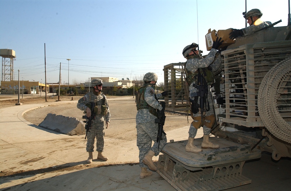 Soldiers hand out school supplies