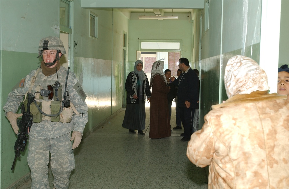 Soldiers hand out school supplies