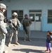 Soldiers hand out school supplies