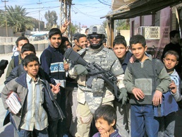Sgt. Conner Poses With Local Children While on Patrol