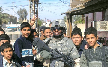 Sgt. Conner Poses With Local Children While on Patrol