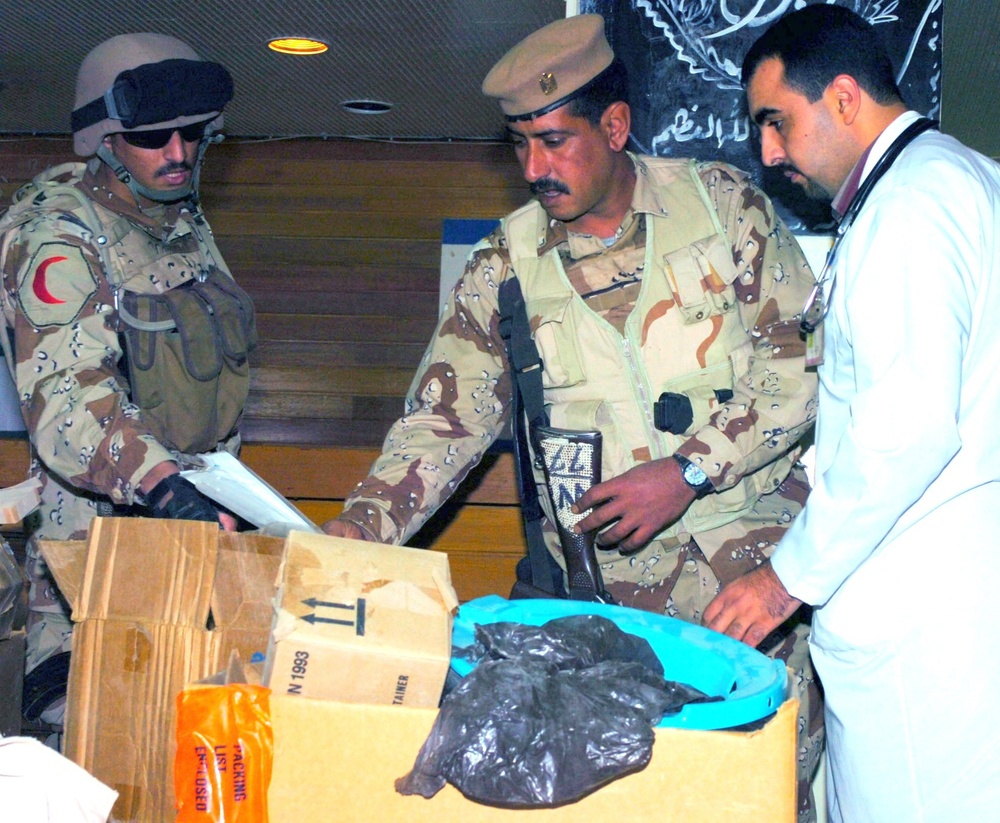 Iraqi Army Soldiers and hospital personnel check medical supplies