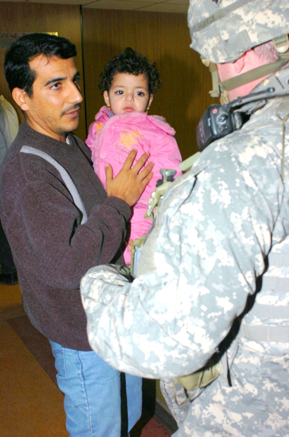 An Iraqi father holds his infant daughter