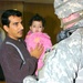 An Iraqi father holds his infant daughter