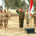 The graduation class cycle 22 salutes during the Iraqi national anthem