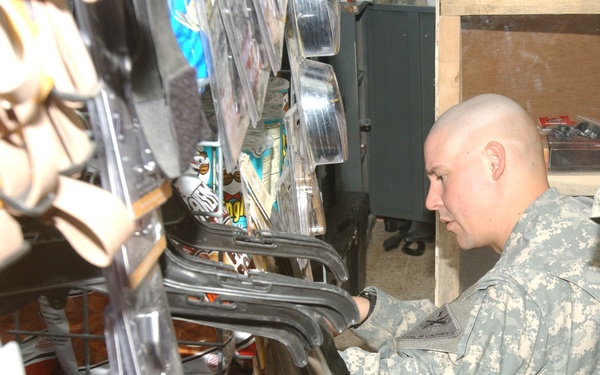Staff Sgt. Hurning stocks and prices items at the Scorpion Outpost