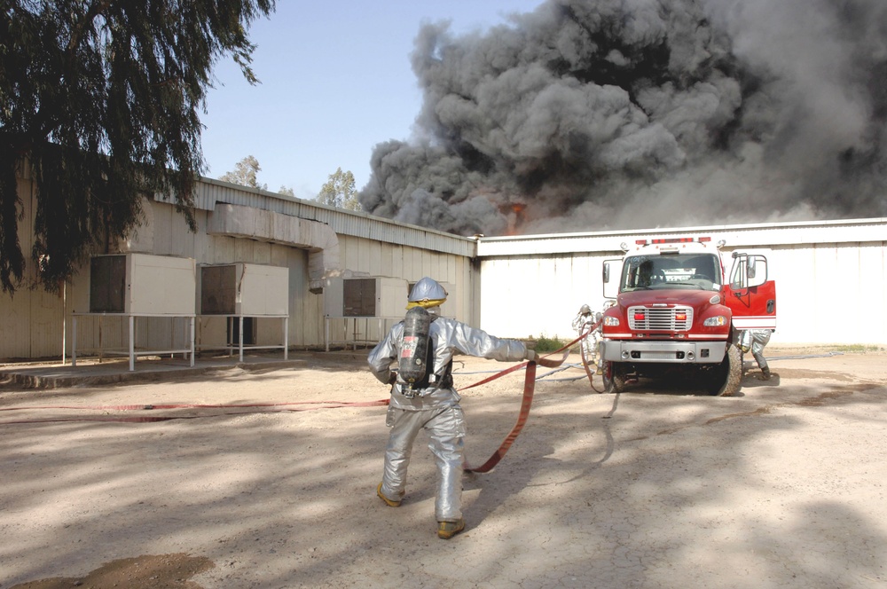 Iraqi, American Firefighters Battle Blaze at Weapons Training Si
