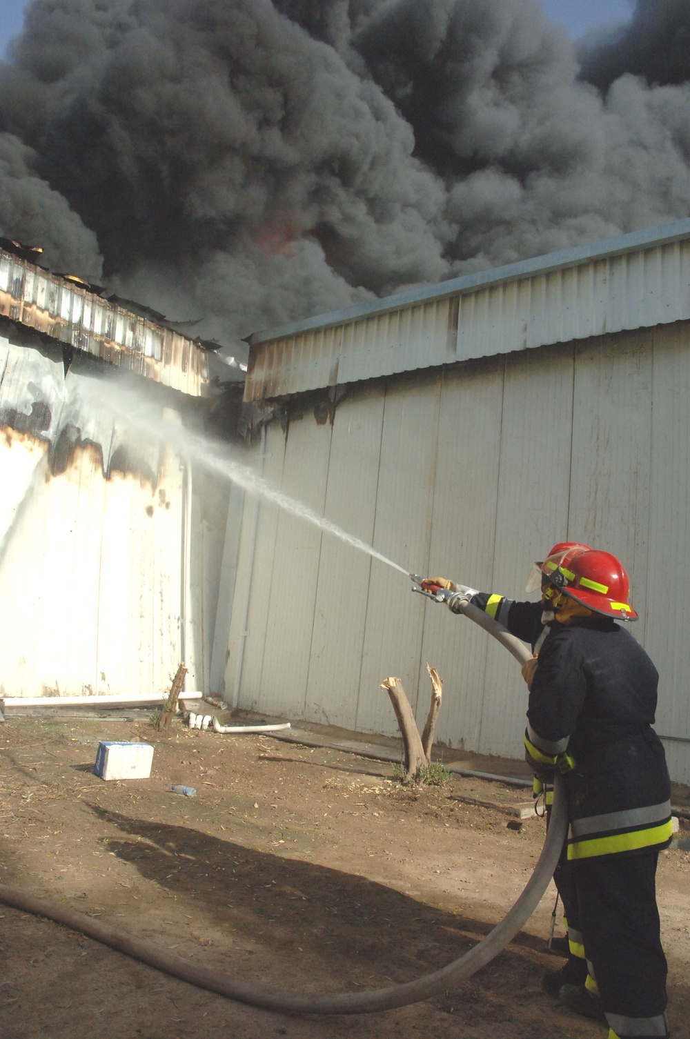 Iraqi, American firefighters battle blaze at weapons training si