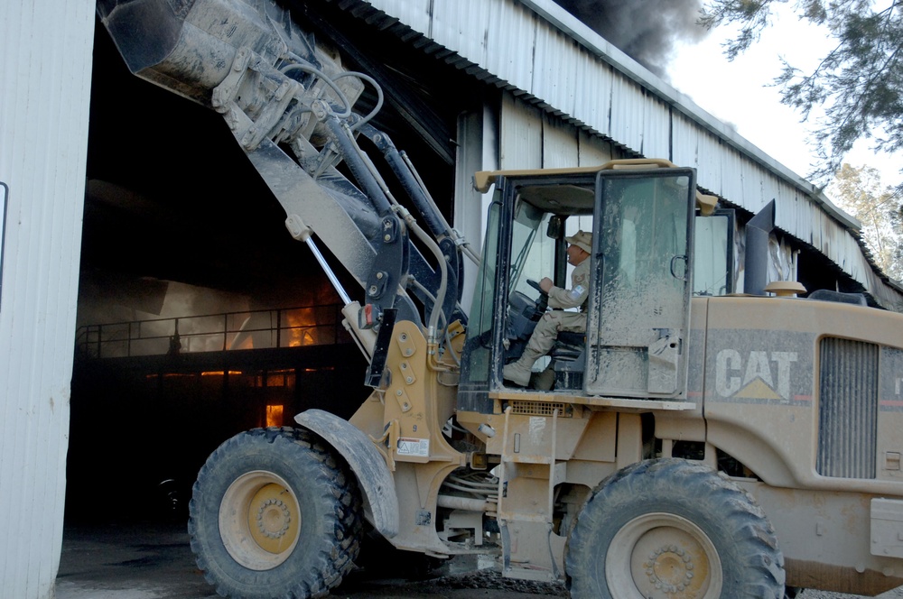 Iraqi, American firefighters battle blaze at weapons training si