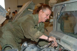 Staff Sgt. Birkman repairs an engine on a humvee