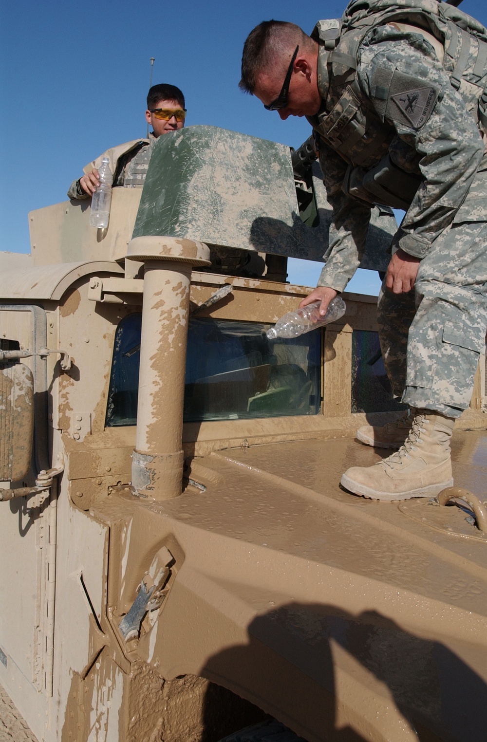 Spc. Phelps cleans his humvee windshield