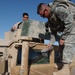 Spc. Phelps cleans his humvee windshield