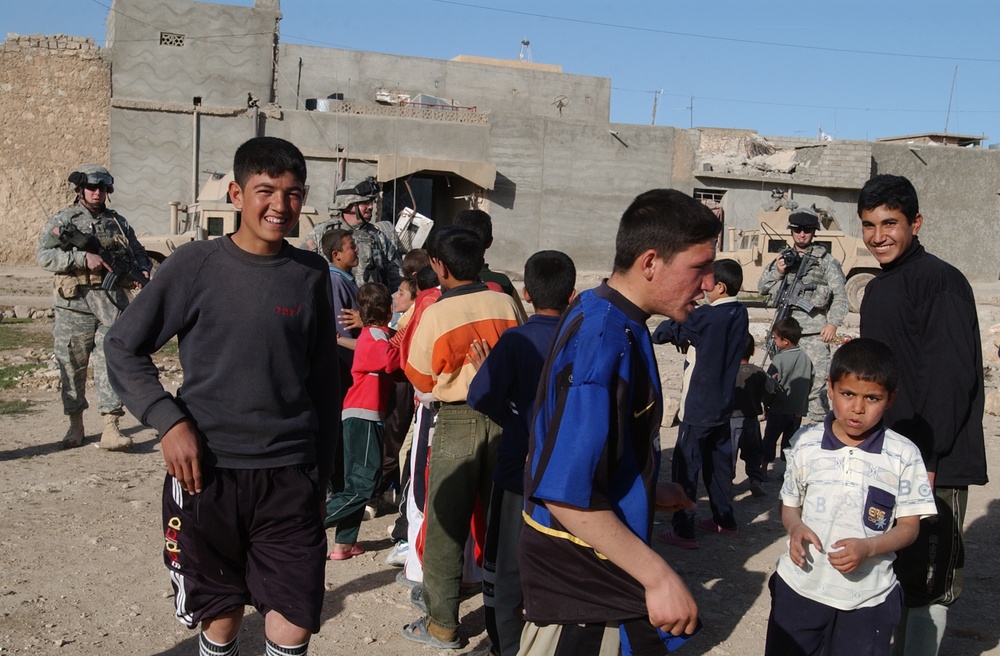 Soldiers hand out soccer balls in Tal Afar