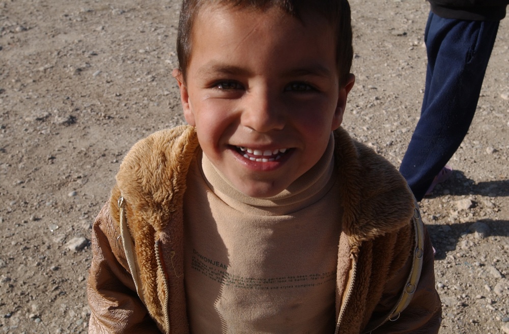 Soldiers hand out soccer balls in Tal Afar