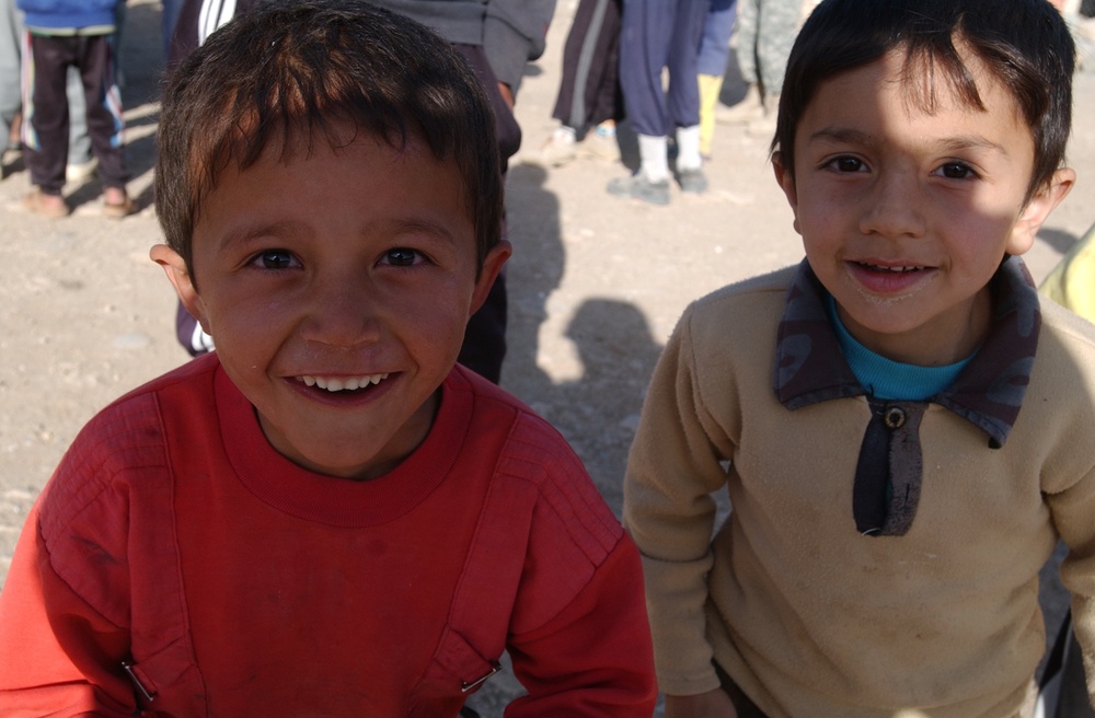 Soldiers hand out soccer balls in Tal Afar