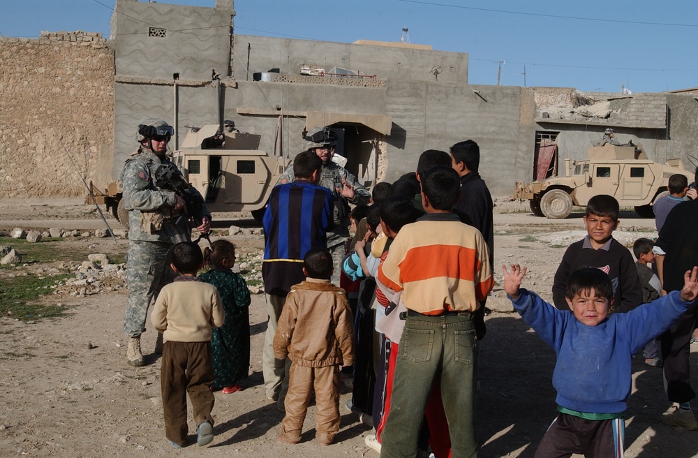 Soldiers hand out soccer balls in Tal Afar