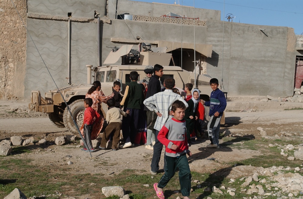 Soldiers hand out soccer balls in Tal Afar