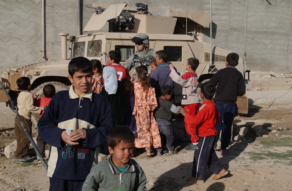 Soldiers hand out soccer balls in Tal Afar