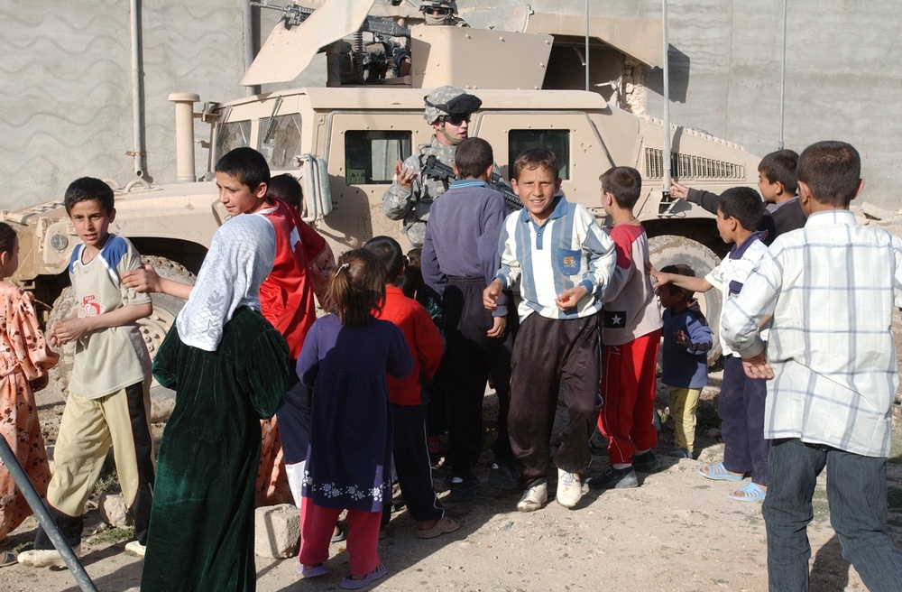 Soldiers hand out soccer balls in Tal Afar