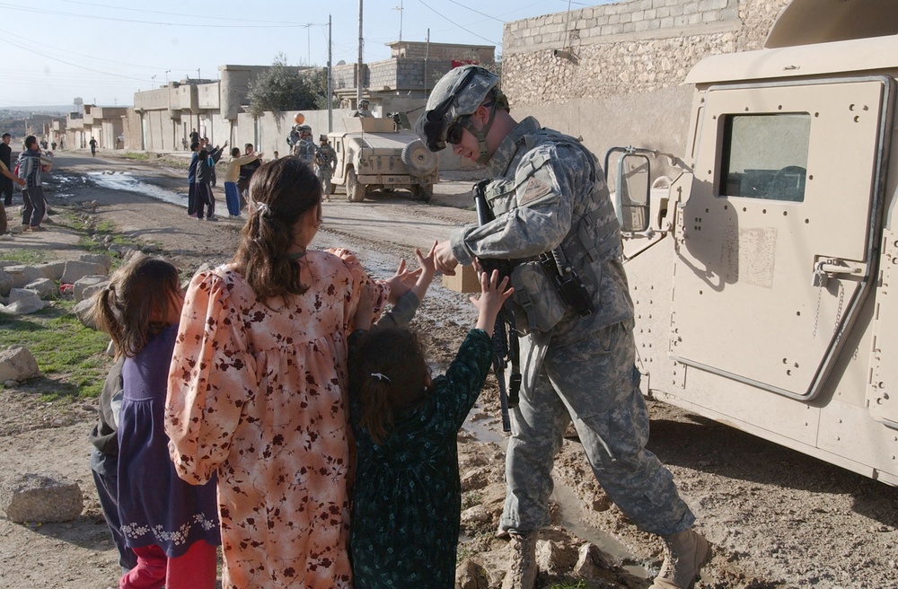 Soldiers hand out soccer balls in Tal Afar