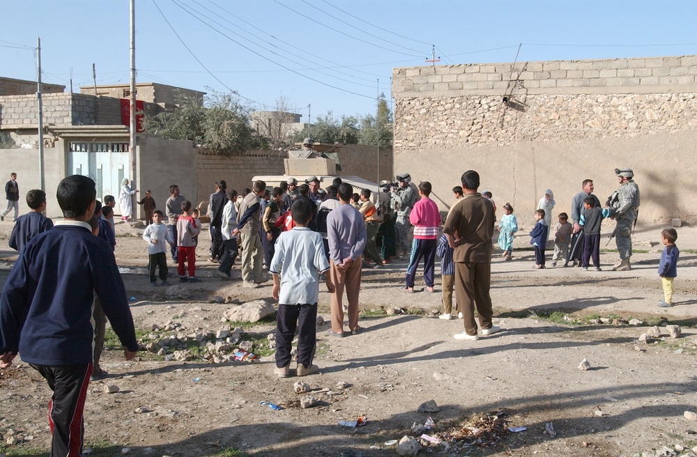 Soldiers hand out soccer balls in Tal Afar