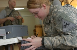 Pfc. Hunt helps a Soldier receive casual pay