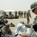 Sgt. 1st Class Birkman reads a Stars and Stripes