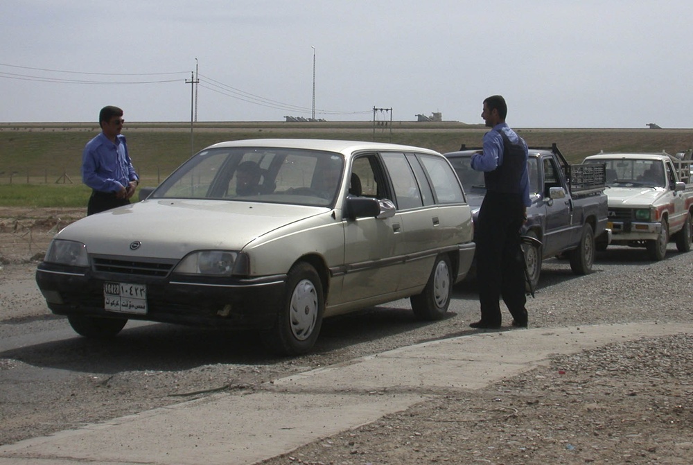 Iraqi Police in Taza check cars at a control point