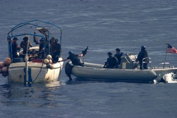 Decatur crewmembers assist the crew of a distressed vessel
