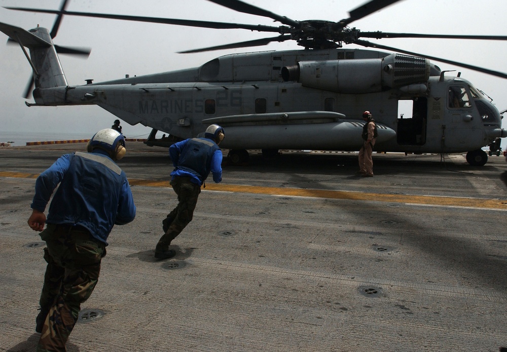 A CH-53 Super Stallion leaves the deck of USS Peleliu