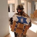 Staff Sgt. Dougherty Carries Boxes of School Supplies
