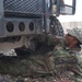 Sgt. Knight bleeds the front brakes on a humvee