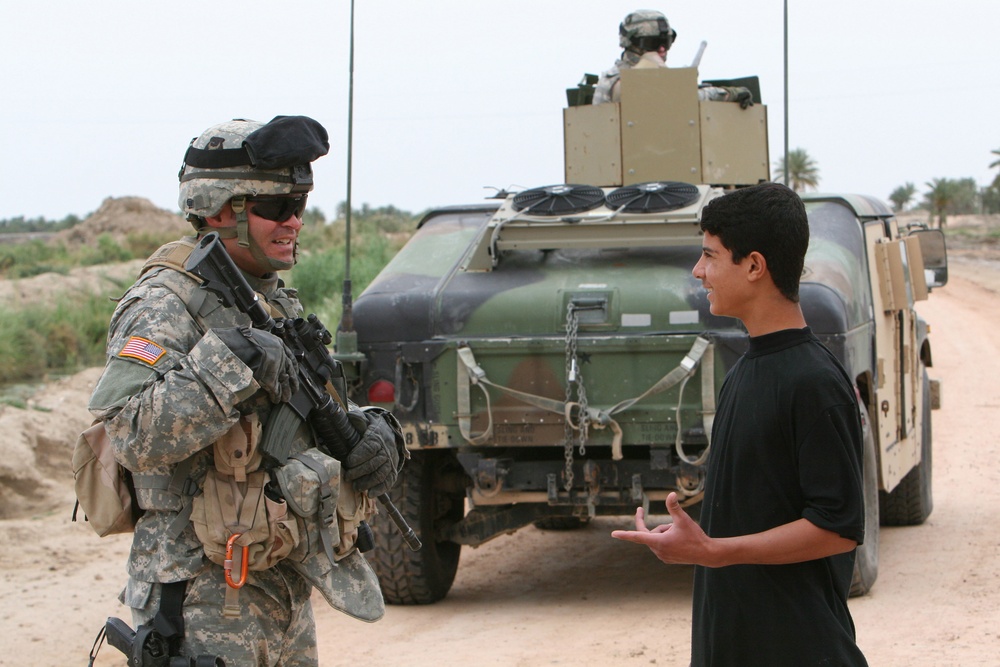 Staff Sgt. Connery talks with an Iraqi boy