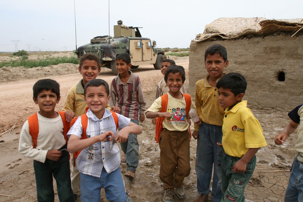 Iraqi children greet Soldiers