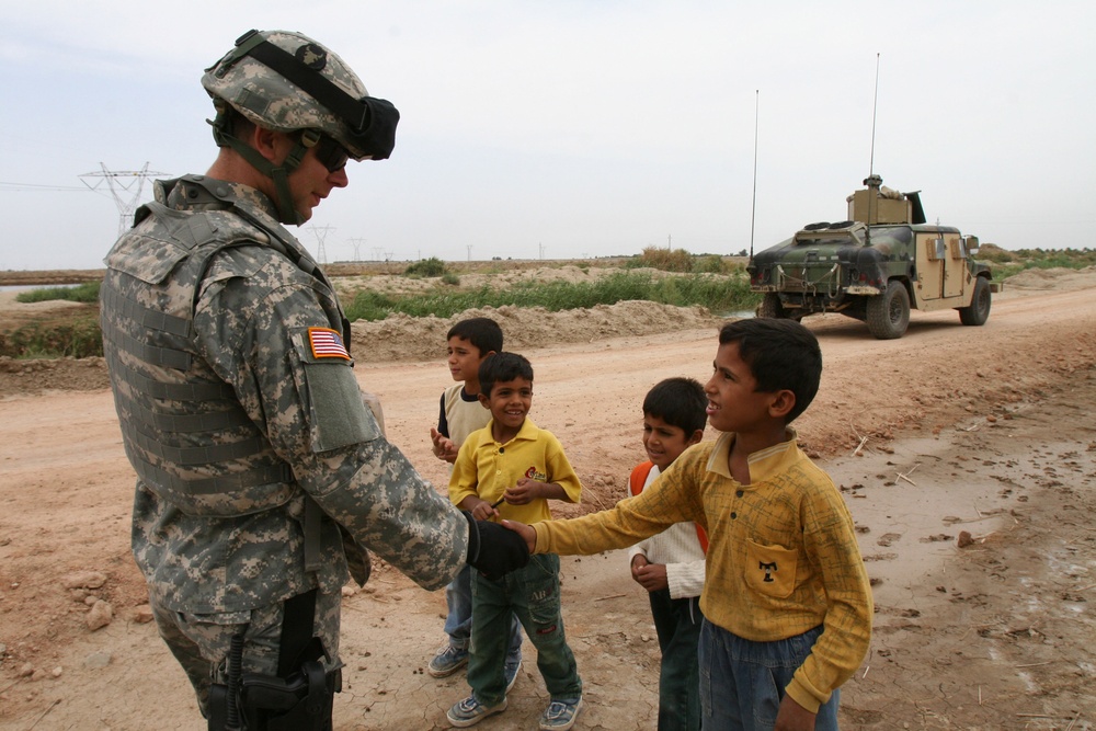 Maj. Peterson greets an Iraqi boy