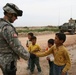 Maj. Peterson greets an Iraqi boy
