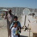 A Iraqi man and his children wave