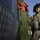 Technical Sgt. De Corte stands next to a HH-60 Pavehawk helicopter Technical Sgt. De Corte stands next to a HH-60 Pavehawk helicopter