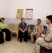 navy Lt. Cmdr Eckert visits womens's center