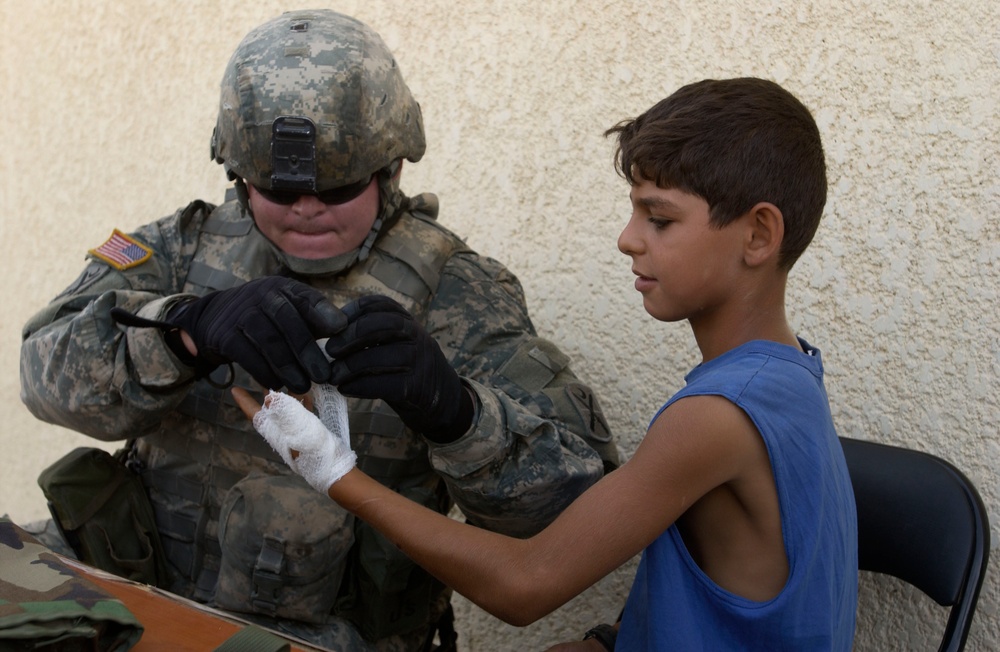 Medic Treat Iraqi Child