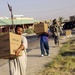 Iraqis Carry Food From US Trucks