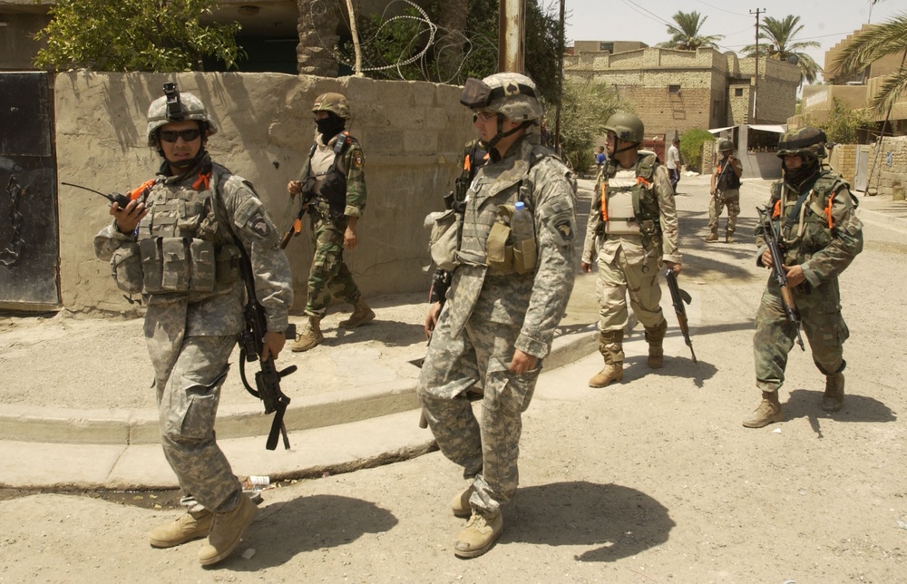 INPs and US Troops Move Through the Streets of Iraq