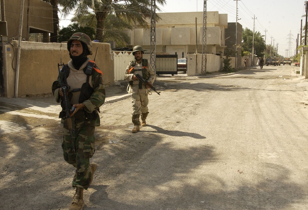 Iraqis Move Through Al Dora