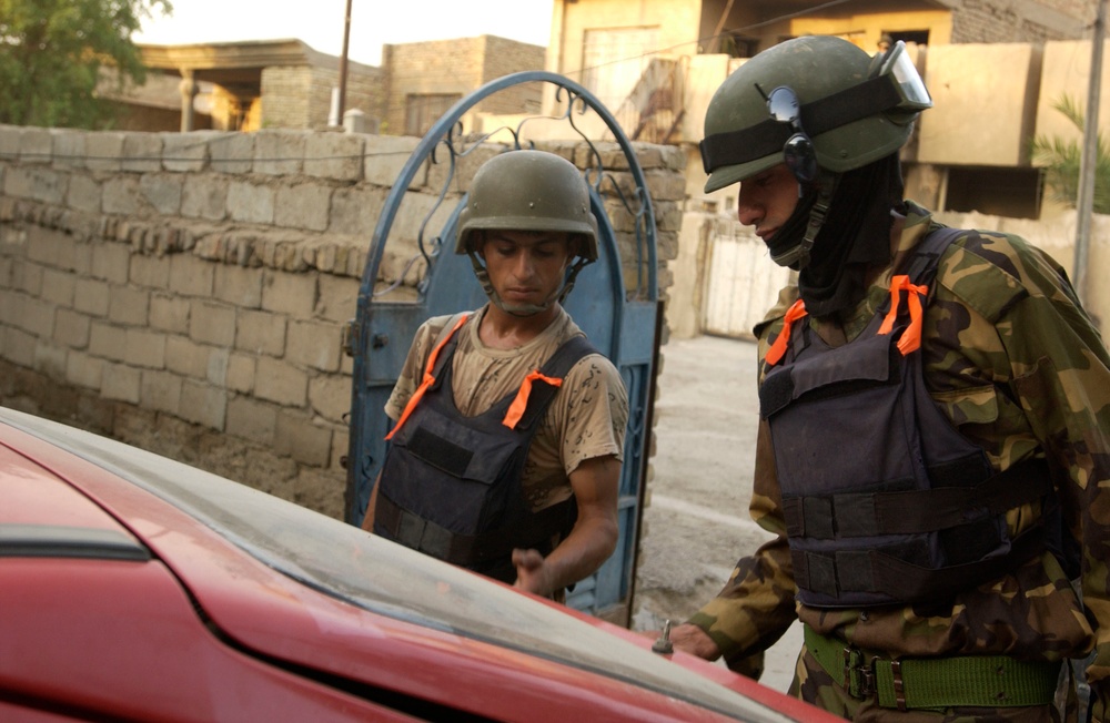 Iraqis Search Vehicles in Dora