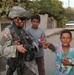 Pfc. Poulin Shows a Few Iraqi Children Their Pictures in Her Camera