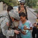 Pfc. Poulin shows a few Iraqi children their pictures in her camera