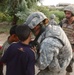 Pfc. Poulin shows a few Iraqi children their pictures in her camera