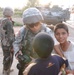 Pfc. Poulin shows a few Iraqi children their pictures in her camera