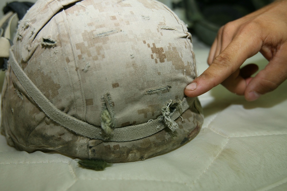 Hard-headed Marine walks away from shot to helmet